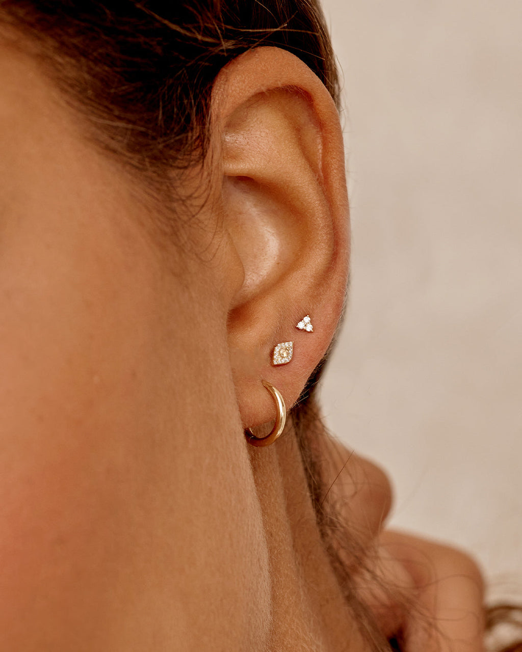Woman wearing Classic Gold Huggie || option::14K Solid Gold, 11mm || set::14K-gold-classic-11mm-huggies-stl