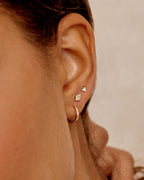 Woman wearing Classic Gold Huggie || option::14K Solid Gold, 11mm || set::14K-gold-classic-11mm-huggies-stl