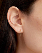 Woman wearing Classic Gold Huggie || option::14K Solid Gold, 15mm