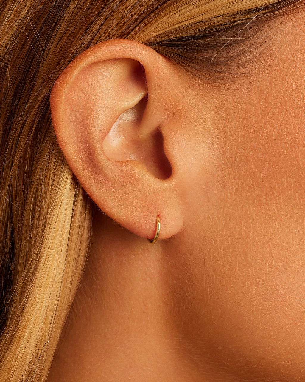 Woman wearing Classic Gold Huggie || option::14K Solid Gold, 8mm