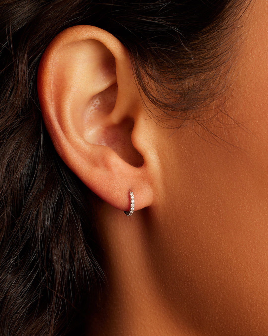 Woman wearing Classic Gold Huggie || option::14K Solid White Gold, 9mm