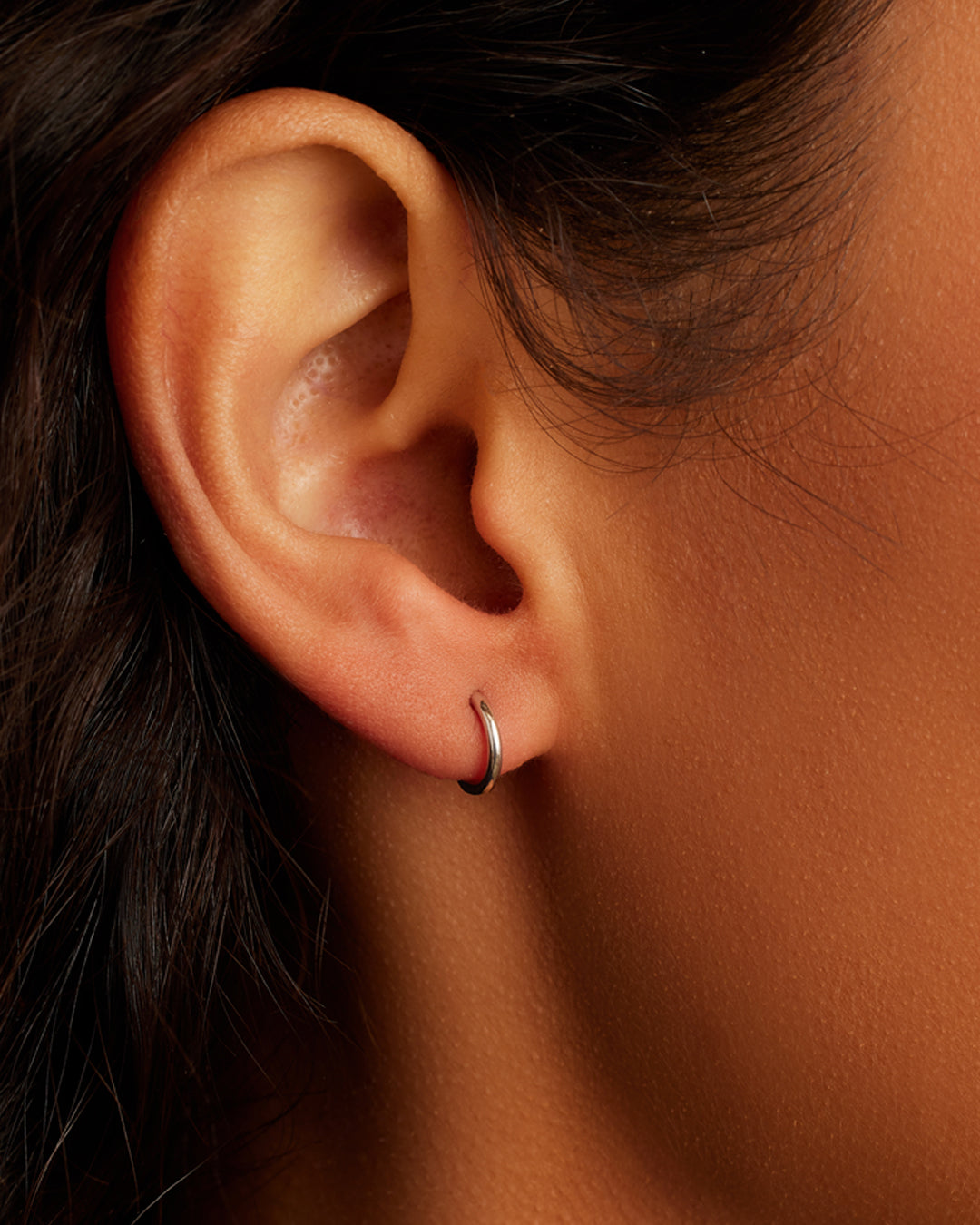 Woman wearing Classic Gold Huggie || option::14K Solid White Gold, 8mm